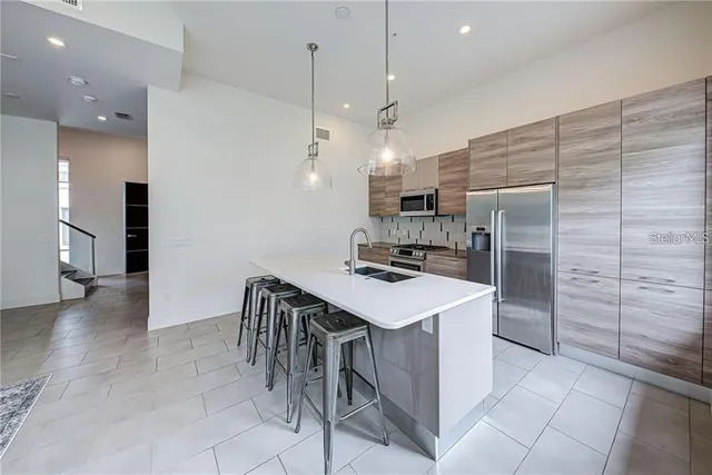 a kitchen with kitchen island a sink appliances and cabinets