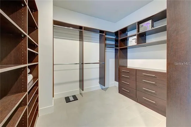 a view of walk in closet with empty racks