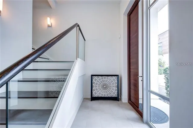a view of entryway and hall with wooden floor