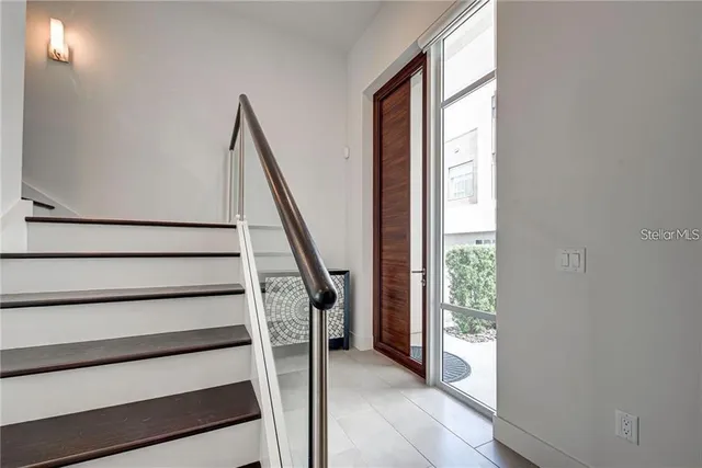a view of entryway with wooden floor and stairs