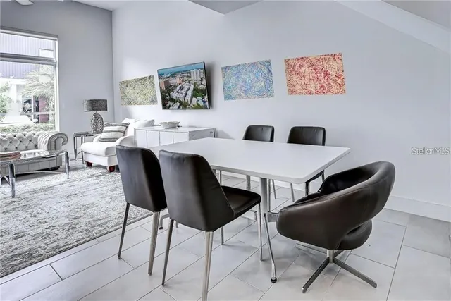 a view of a dining room with furniture and a rug
