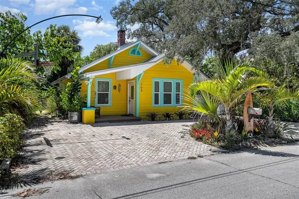 a front view of a house with plants