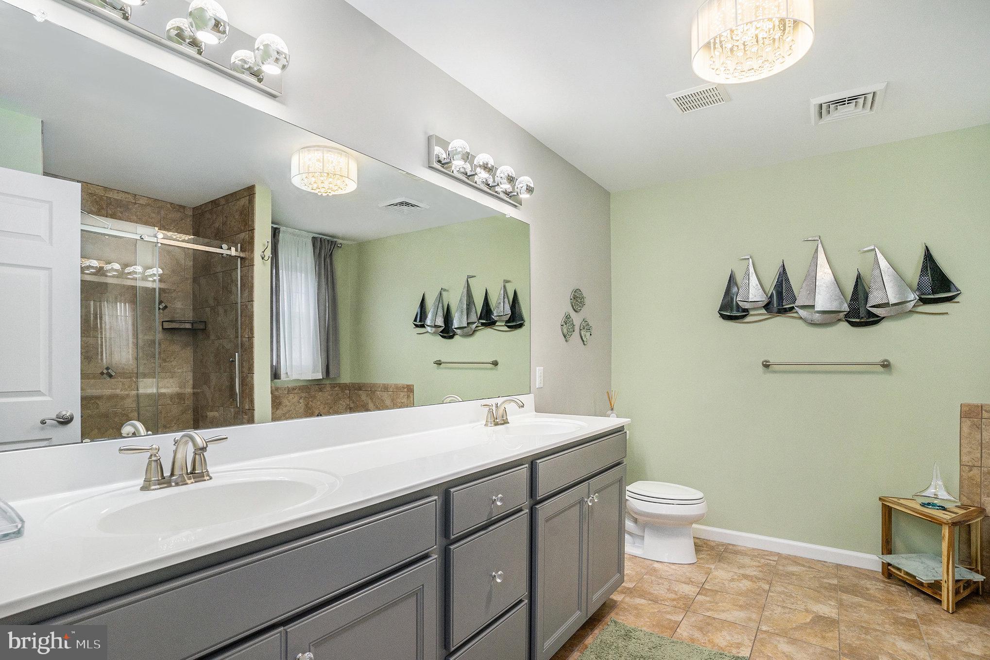 472 Evansburg Road Collegeville, PA 19426 - Photo 28 of 48 a bathroom with a double vanity sink a toilet and a mirror