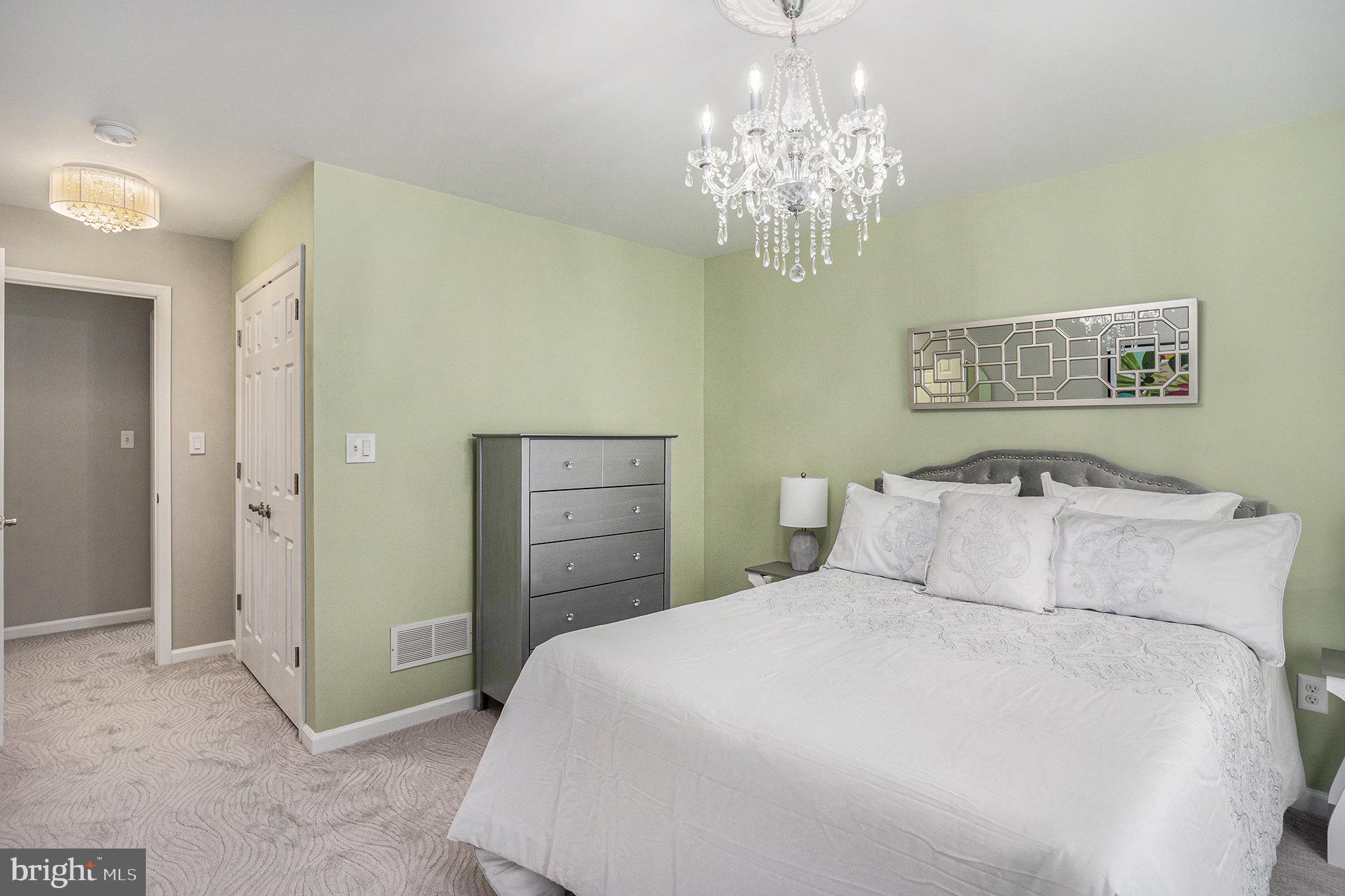 472 Evansburg Road Collegeville, PA 19426 - Photo 29 of 48 a bedroom with a bed and a chandelier