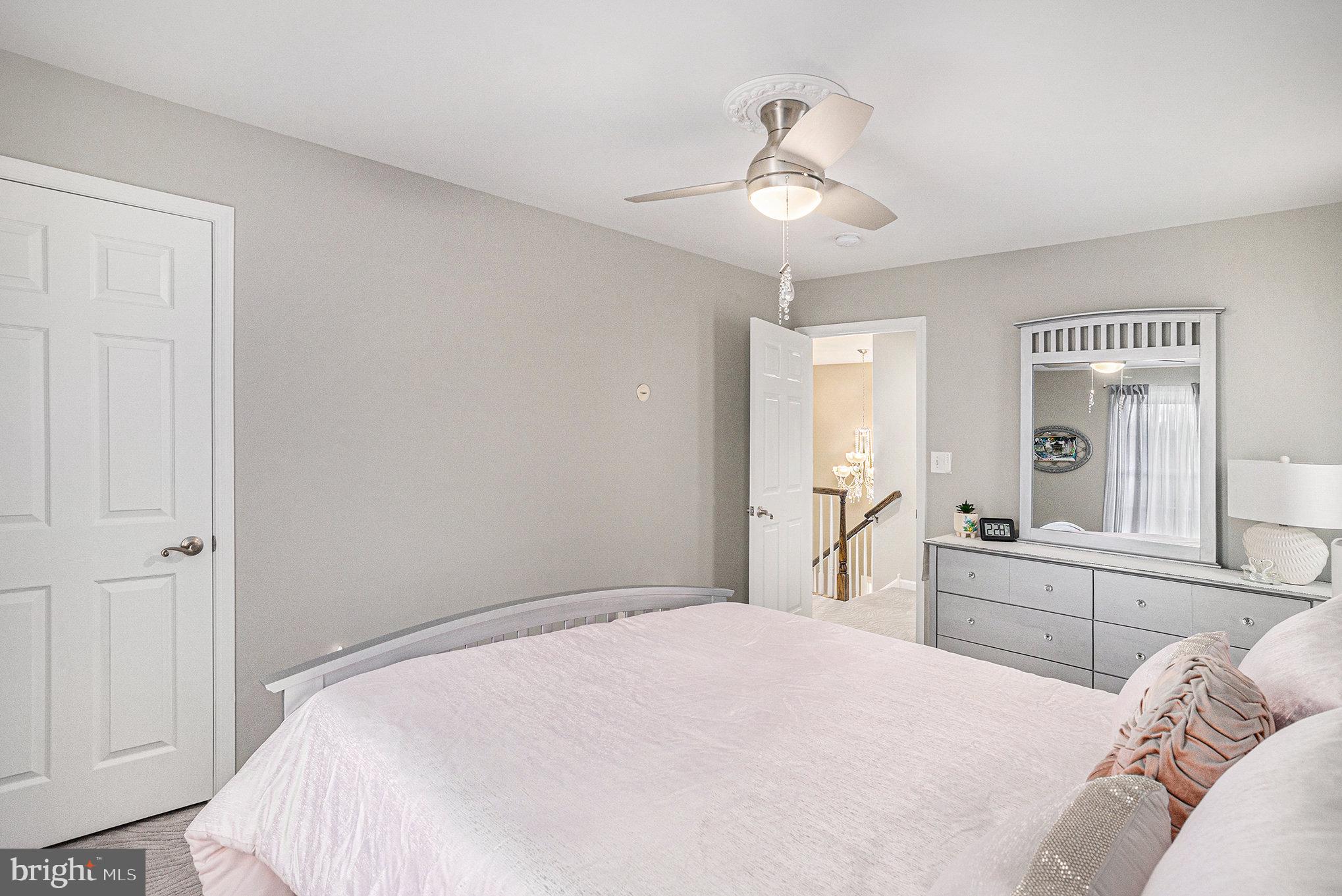 472 Evansburg Road Collegeville, PA 19426 - Photo 34 of 48 a bedroom with a large bed and a chandelier
