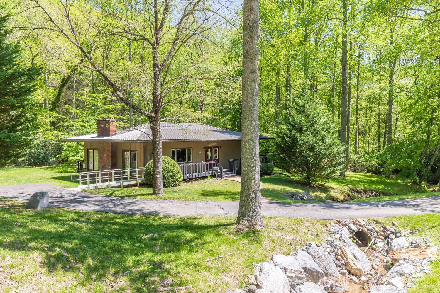 89 Weeping Cherry Forest Road Fairview, NC 28730 - Photo 11 of 15 a view of a house with backyard and sitting area