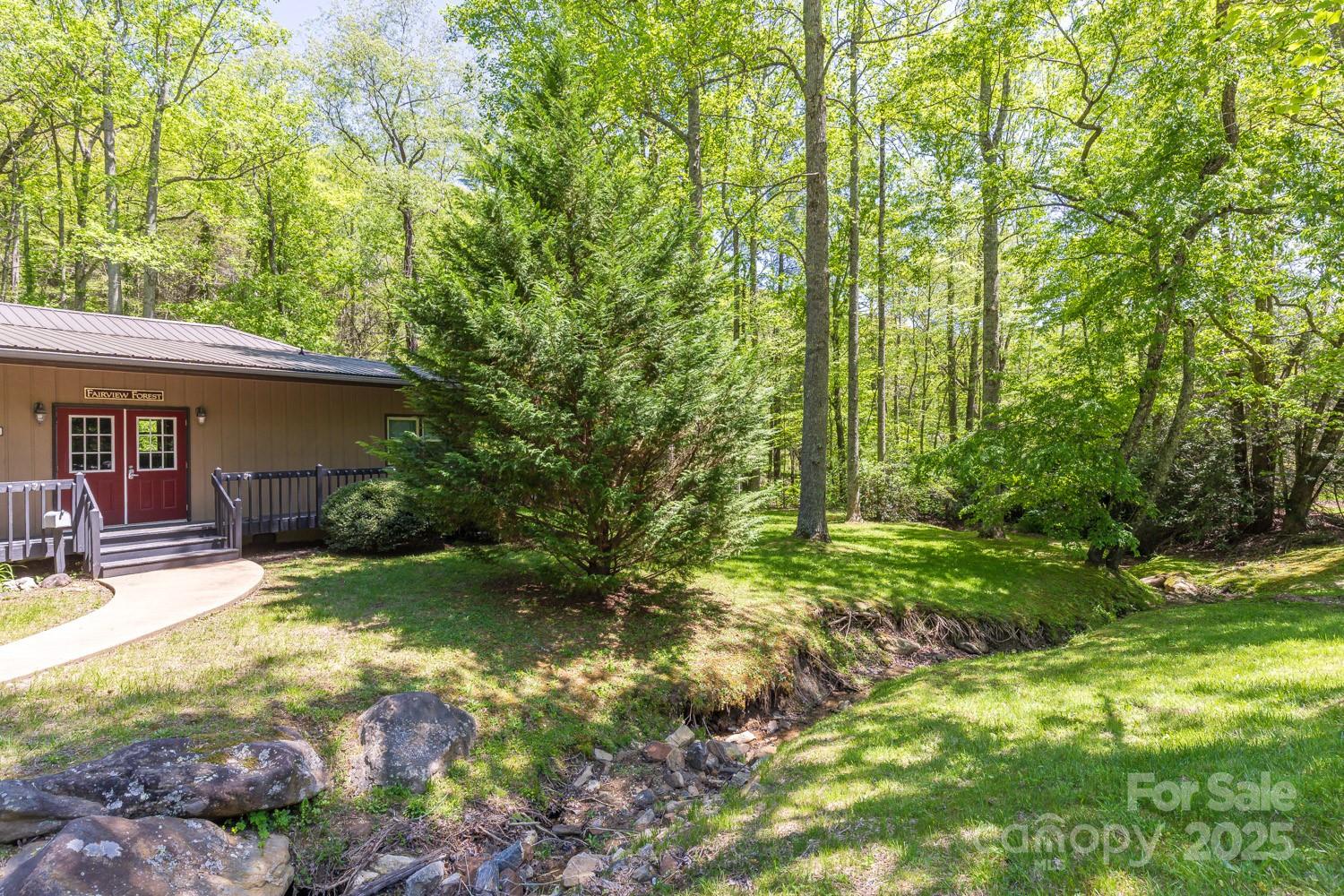 89 Weeping Cherry Forest Road Fairview, NC 28730 - Photo 8 of 15 a view of a house with backyard and sitting area
