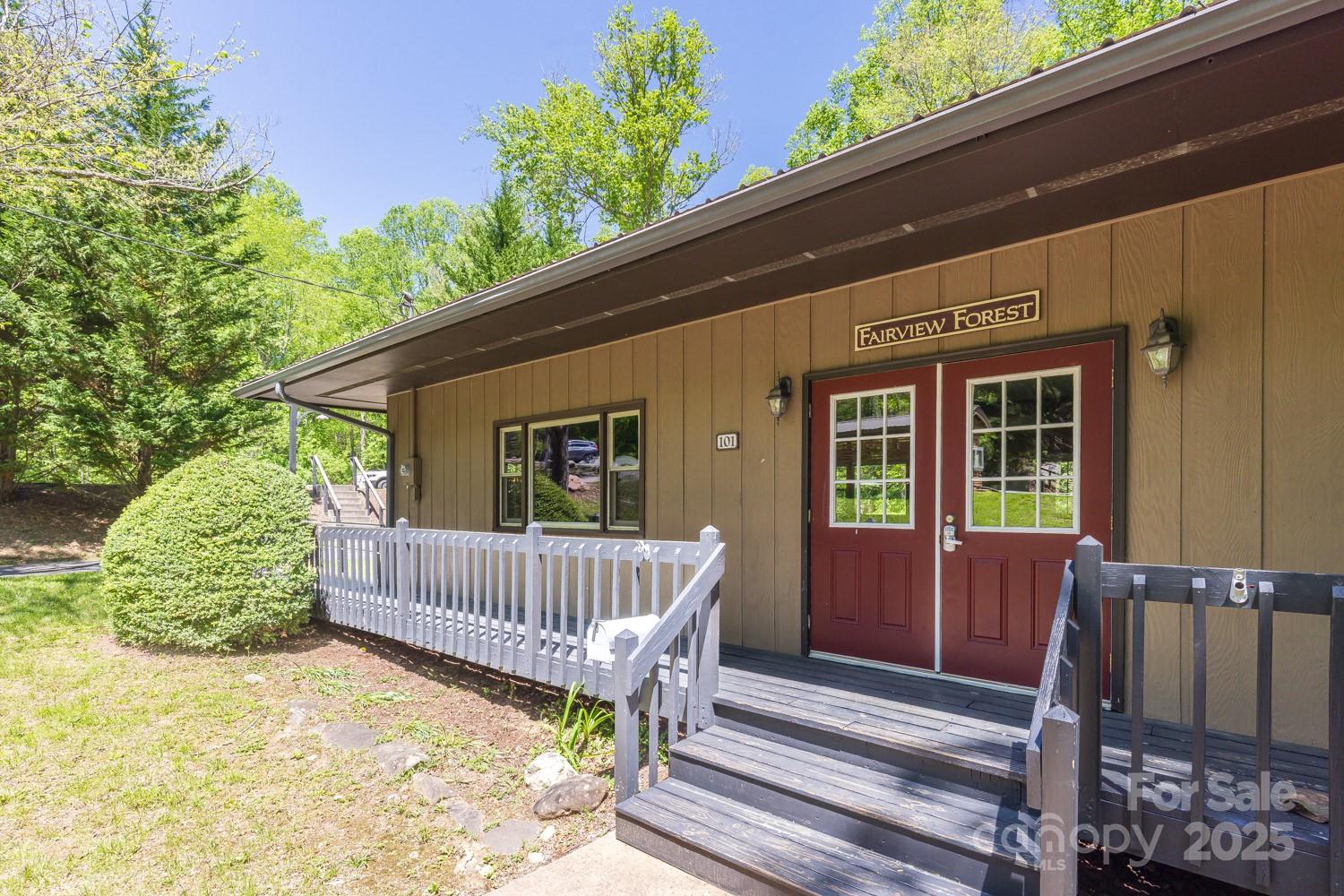 89 Weeping Cherry Forest Road Fairview, NC 28730 - Photo 9 of 15 a view of a house with a wooden deck and a chair