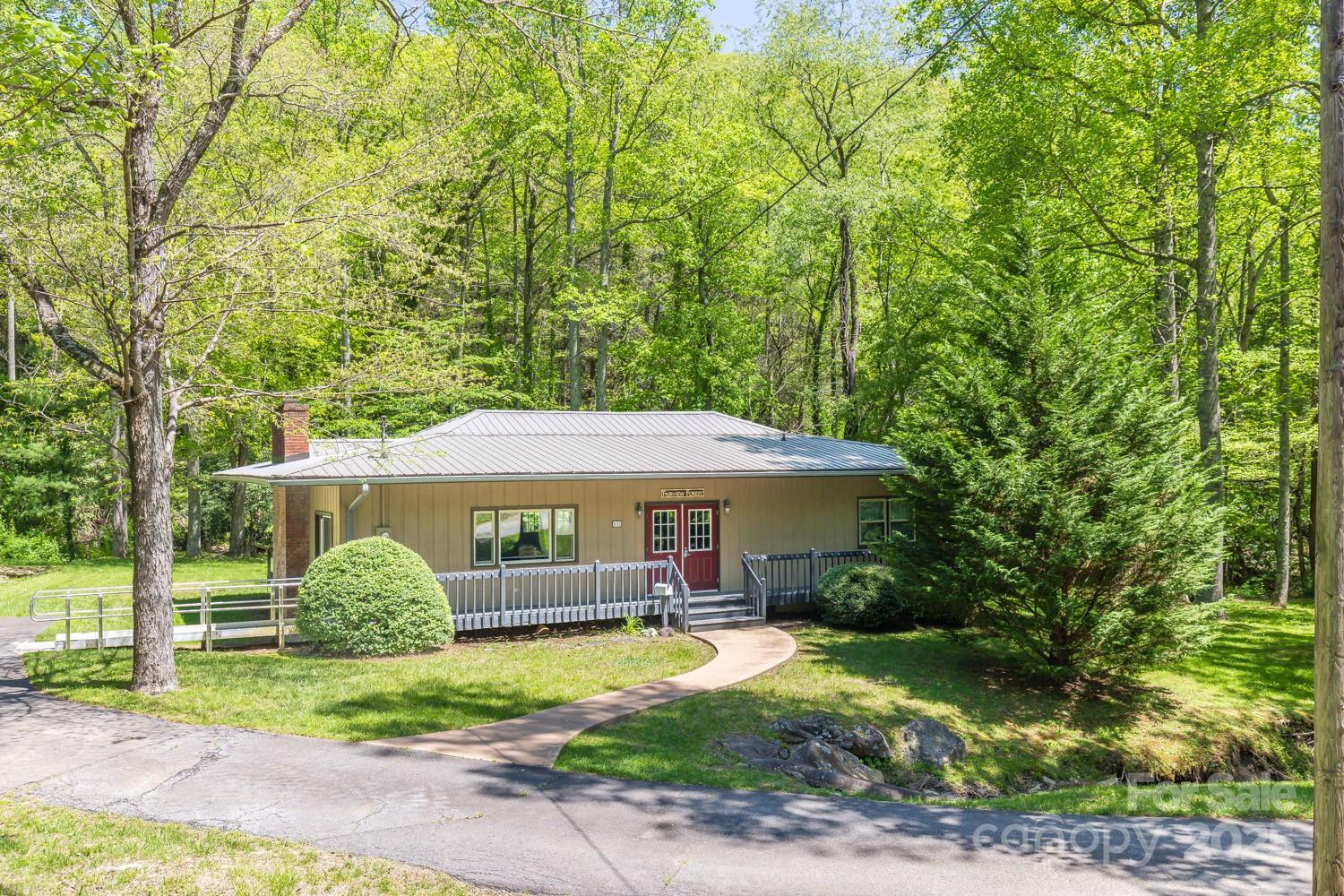 89 Weeping Cherry Forest Road Fairview, NC 28730 - Photo 10 of 15 a table and chairs under an umbrella
