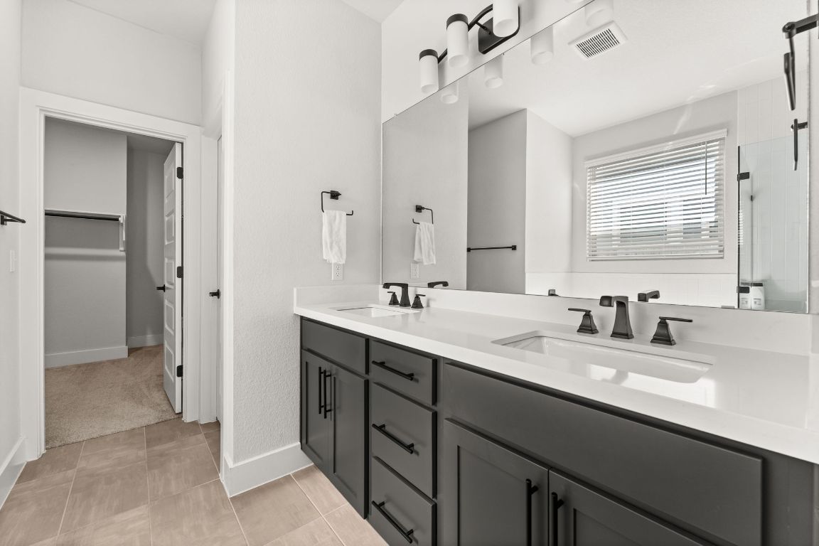 8512 McKamy Drive Austin, TX 78744 - Photo 15 of 28 Quartz dual vanities bring style and functionality to the primary bath.