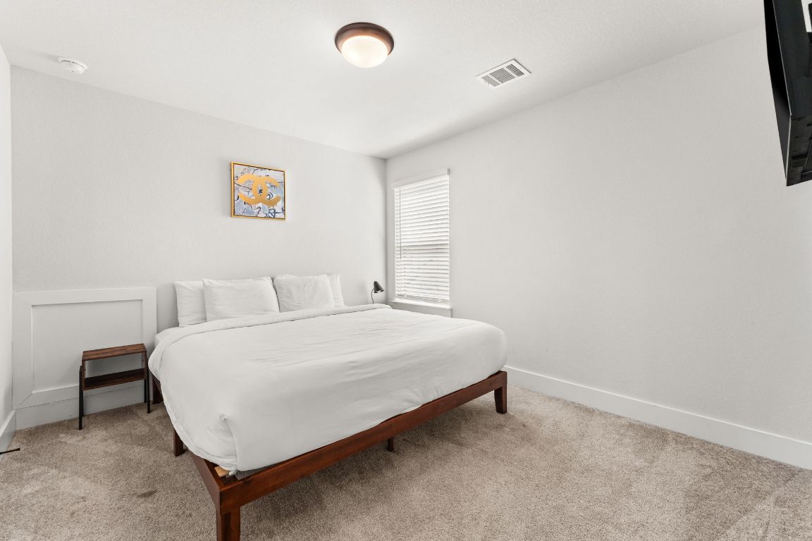 8512 McKamy Drive Austin, TX 78744 - Photo 21 of 28 Neutral tones and natural light make each secondary bedroom inviting.