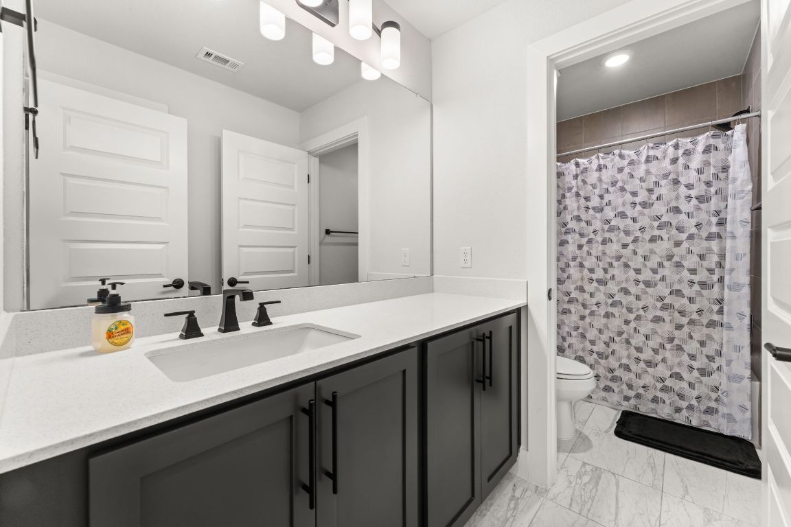 8512 McKamy Drive Austin, TX 78744 - Photo 25 of 28 Bright and fresh bathrooms provide comfort for family and visitors alike.