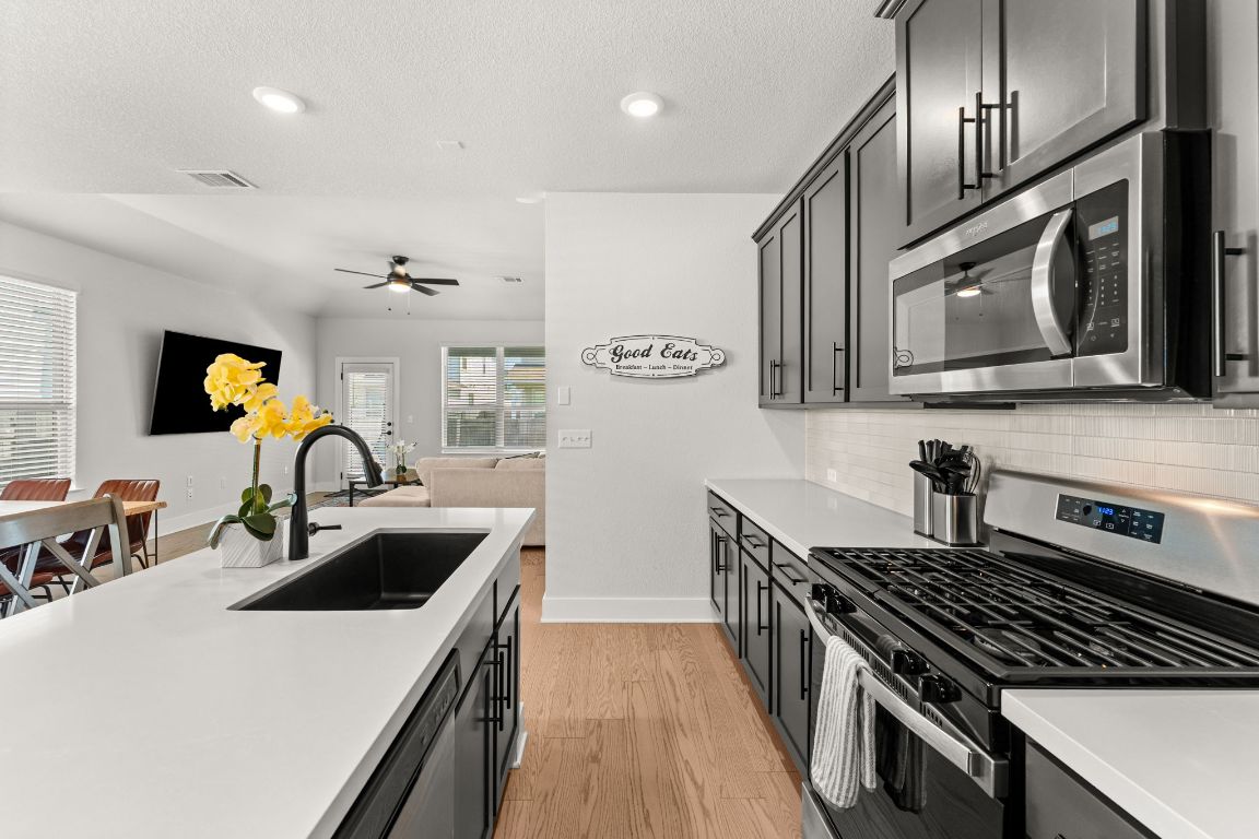 8512 McKamy Drive Austin, TX 78744 - Photo 7 of 28 Stainless steel appliances, including a gas range, make cooking a joy.