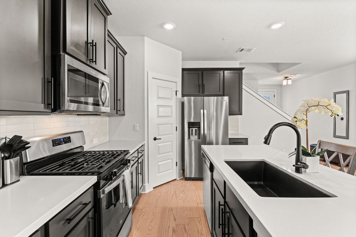8512 McKamy Drive Austin, TX 78744 - Photo 8 of 28 A walk-in corner pantry offers abundant storage for everyday essentials.