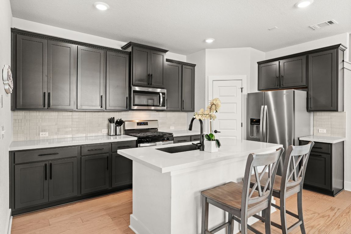 8512 McKamy Drive Austin, TX 78744 - Photo 9 of 28 This kitchen’s sleek design combines beauty with functionality.