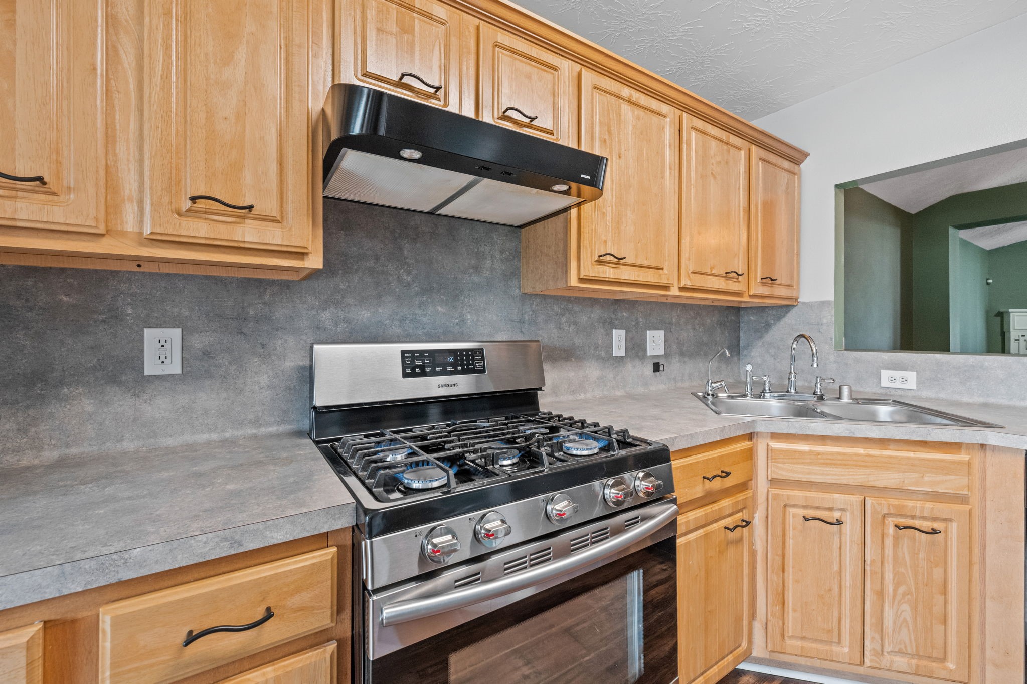 3330 Red Cedar Drive Baytown, TX 77521 - Photo 12 of 25 a kitchen with white cabinets and a stove top oven
