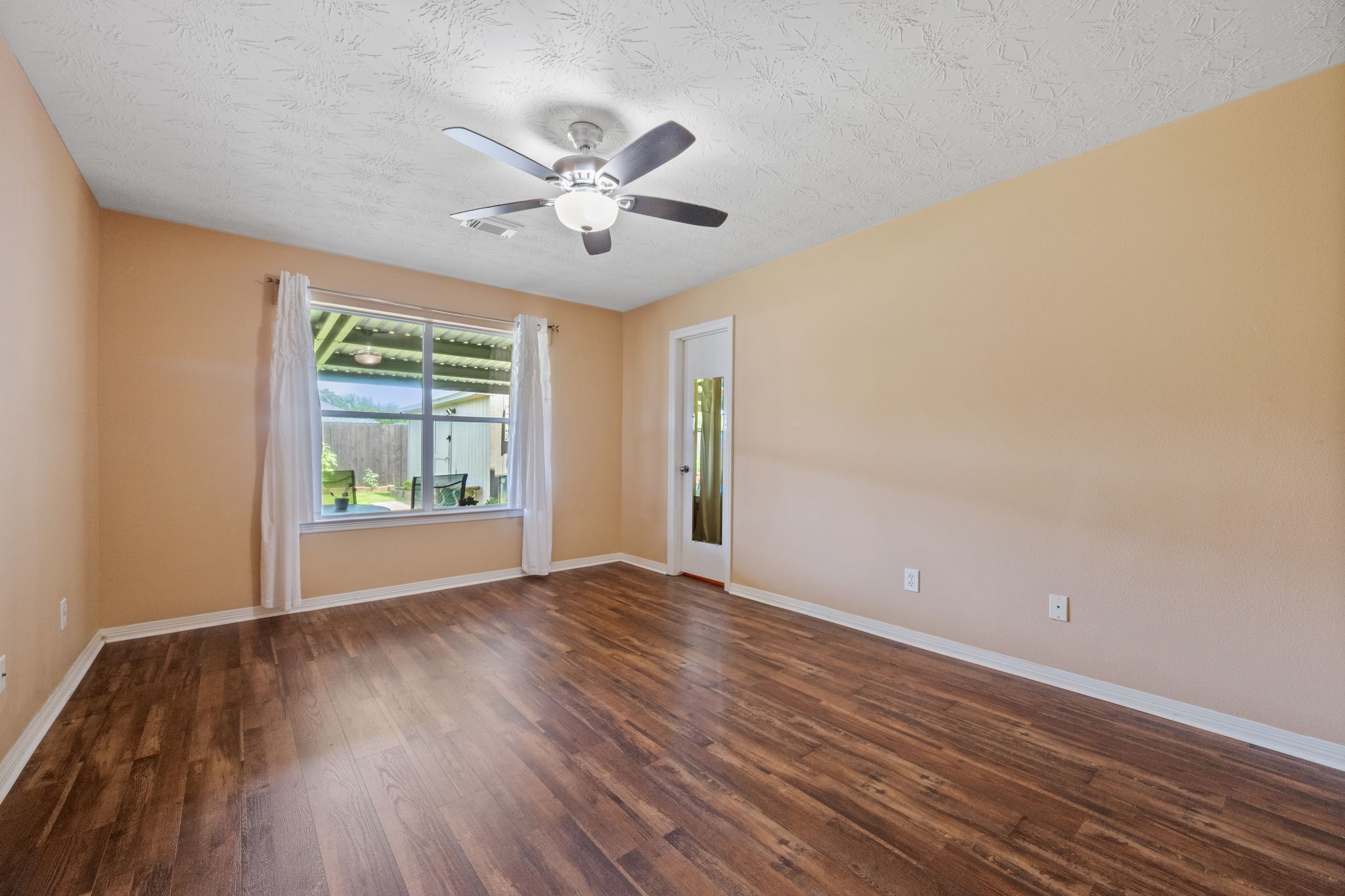 3330 Red Cedar Drive Baytown, TX 77521 - Photo 14 of 25 a view of an empty room with a window and wooden floor