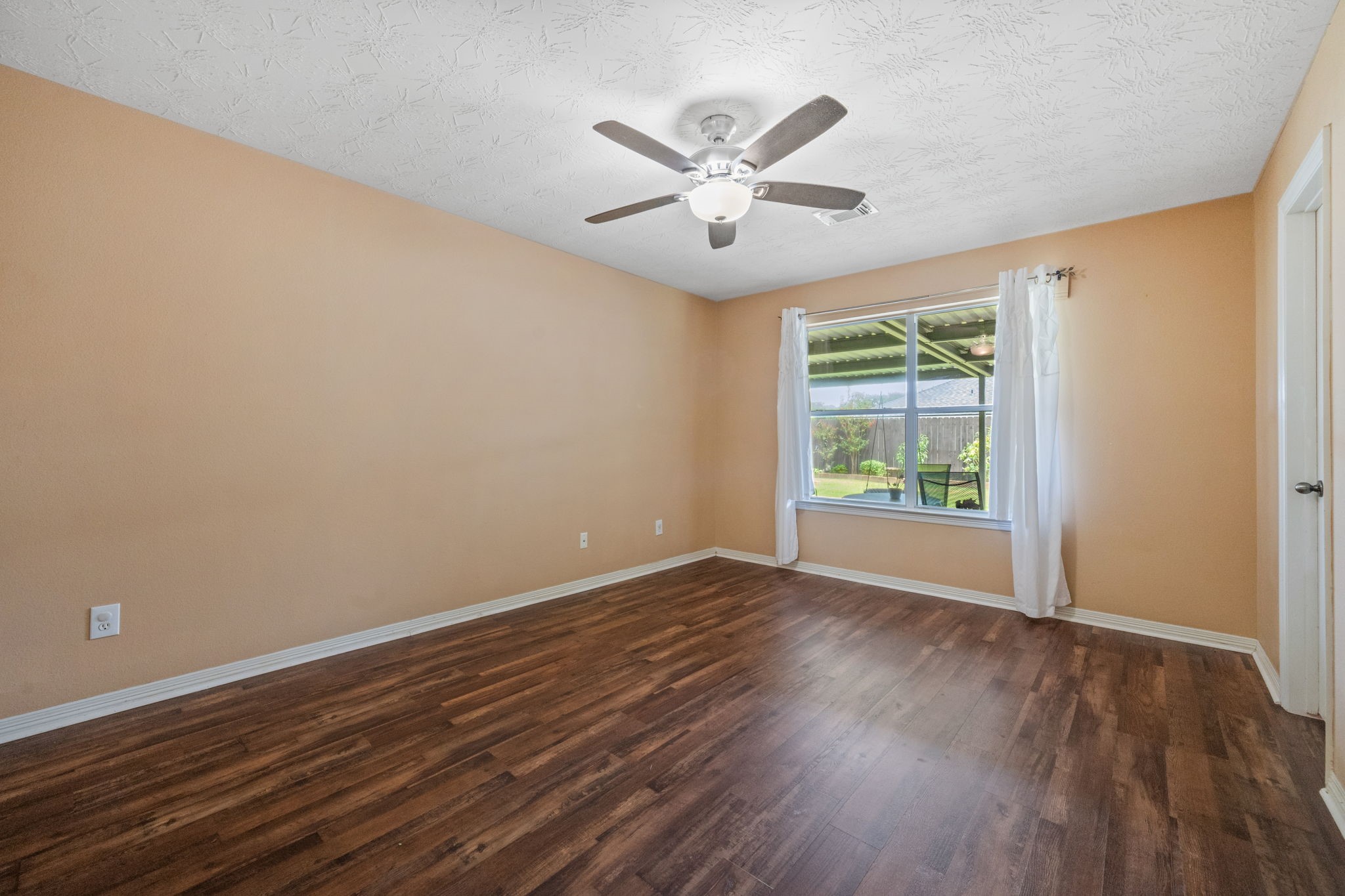 3330 Red Cedar Drive Baytown, TX 77521 - Photo 15 of 25 a view of an empty room with wooden floor and a window