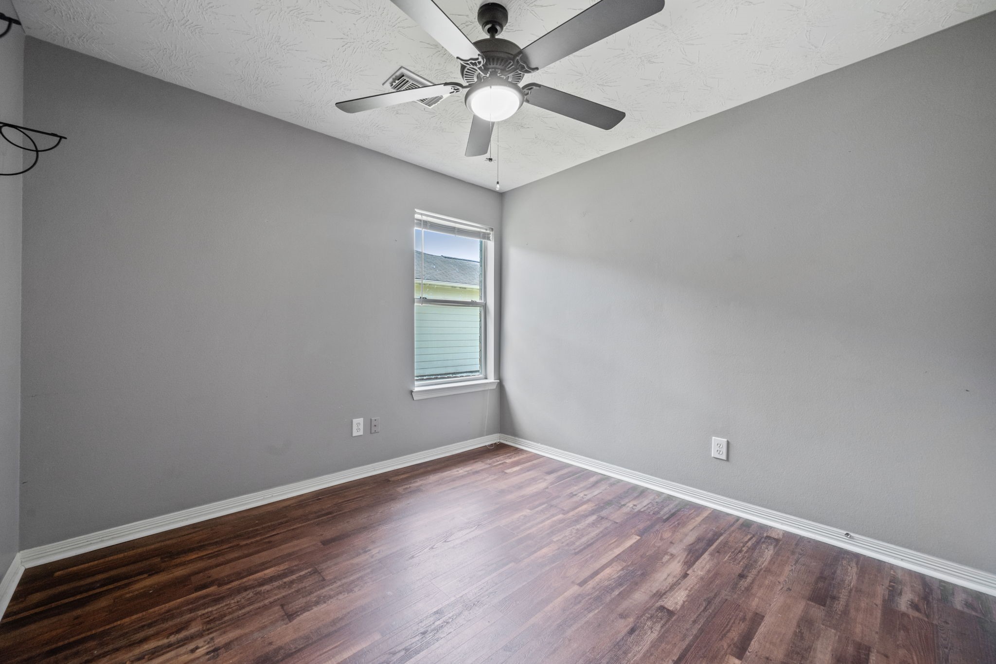 3330 Red Cedar Drive Baytown, TX 77521 - Photo 19 of 25 wooden floor in an empty room with a window