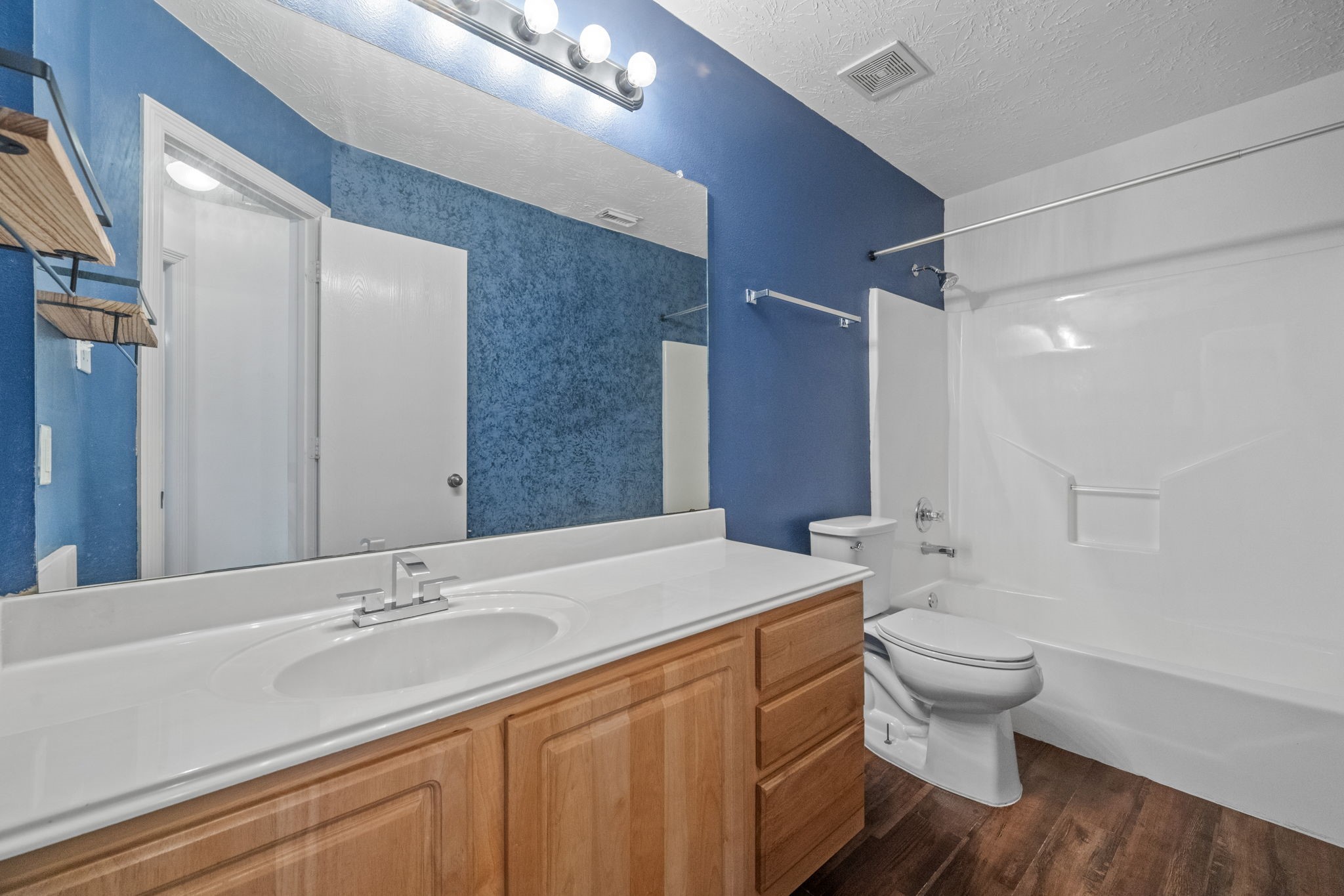 3330 Red Cedar Drive Baytown, TX 77521 - Photo 20 of 25 a bathroom with a sink a toilet and a large mirror