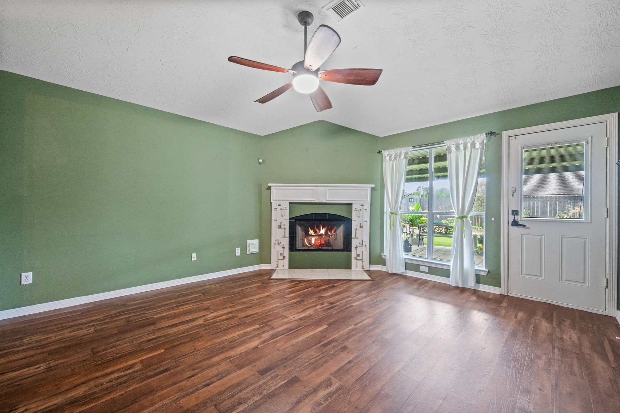 3330 Red Cedar Drive Baytown, TX 77521 - Photo 3 of 25 a view of an empty room with wooden floor and a window