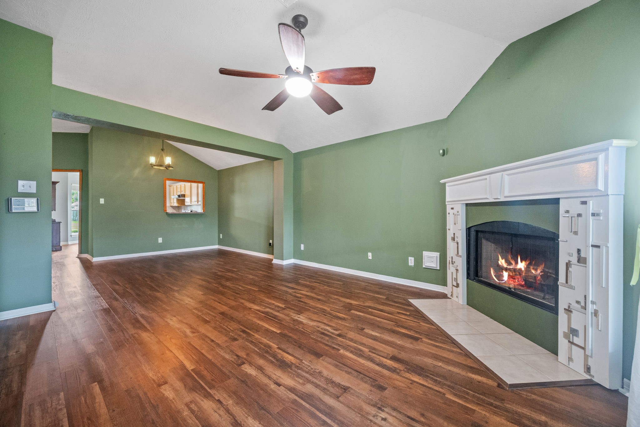 3330 Red Cedar Drive Baytown, TX 77521 - Photo 5 of 25 a view of an empty room with wooden floor fireplace and a window