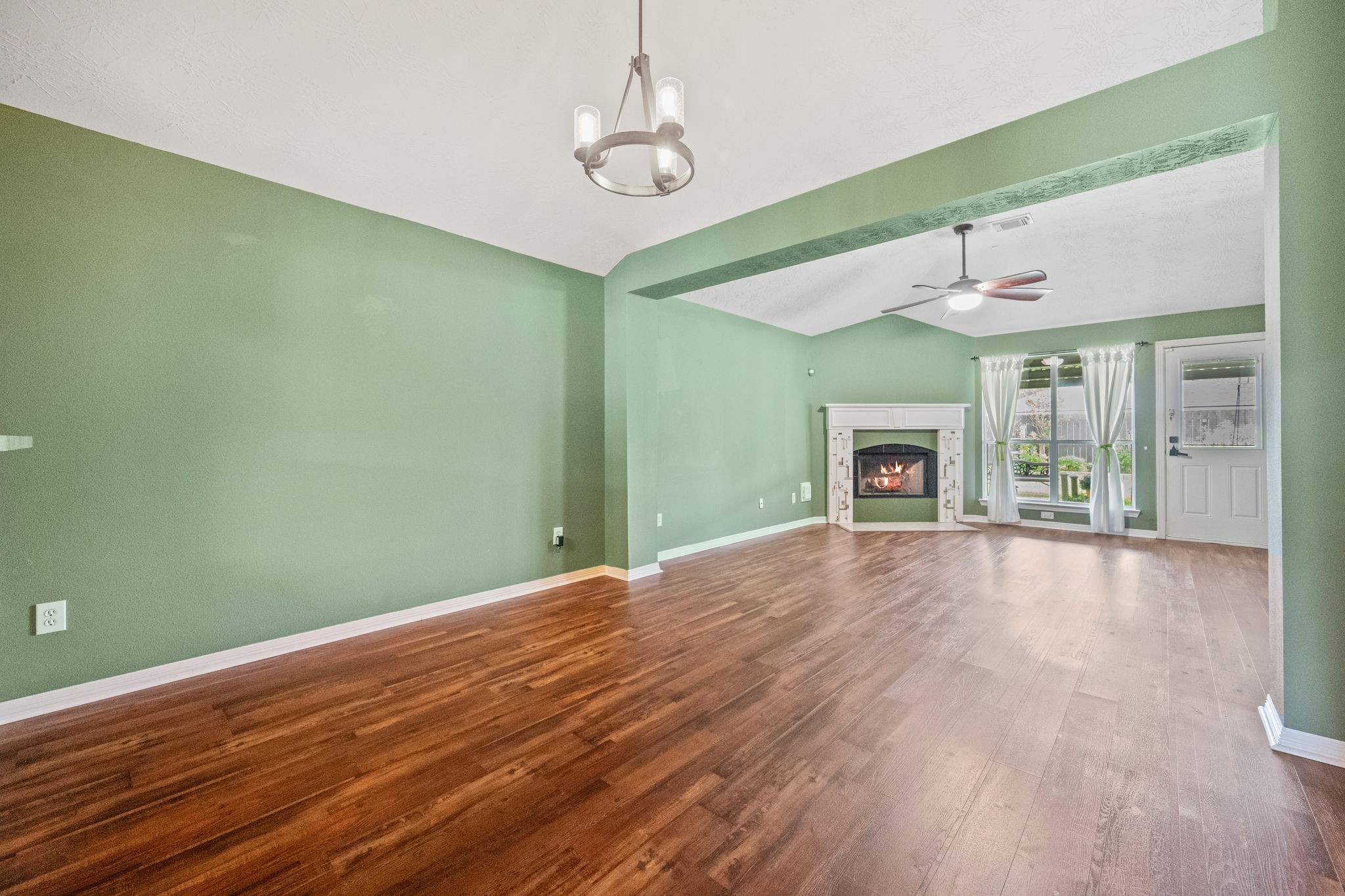 3330 Red Cedar Drive Baytown, TX 77521 - Photo 7 of 25 a view of empty room with wooden floor and fireplace