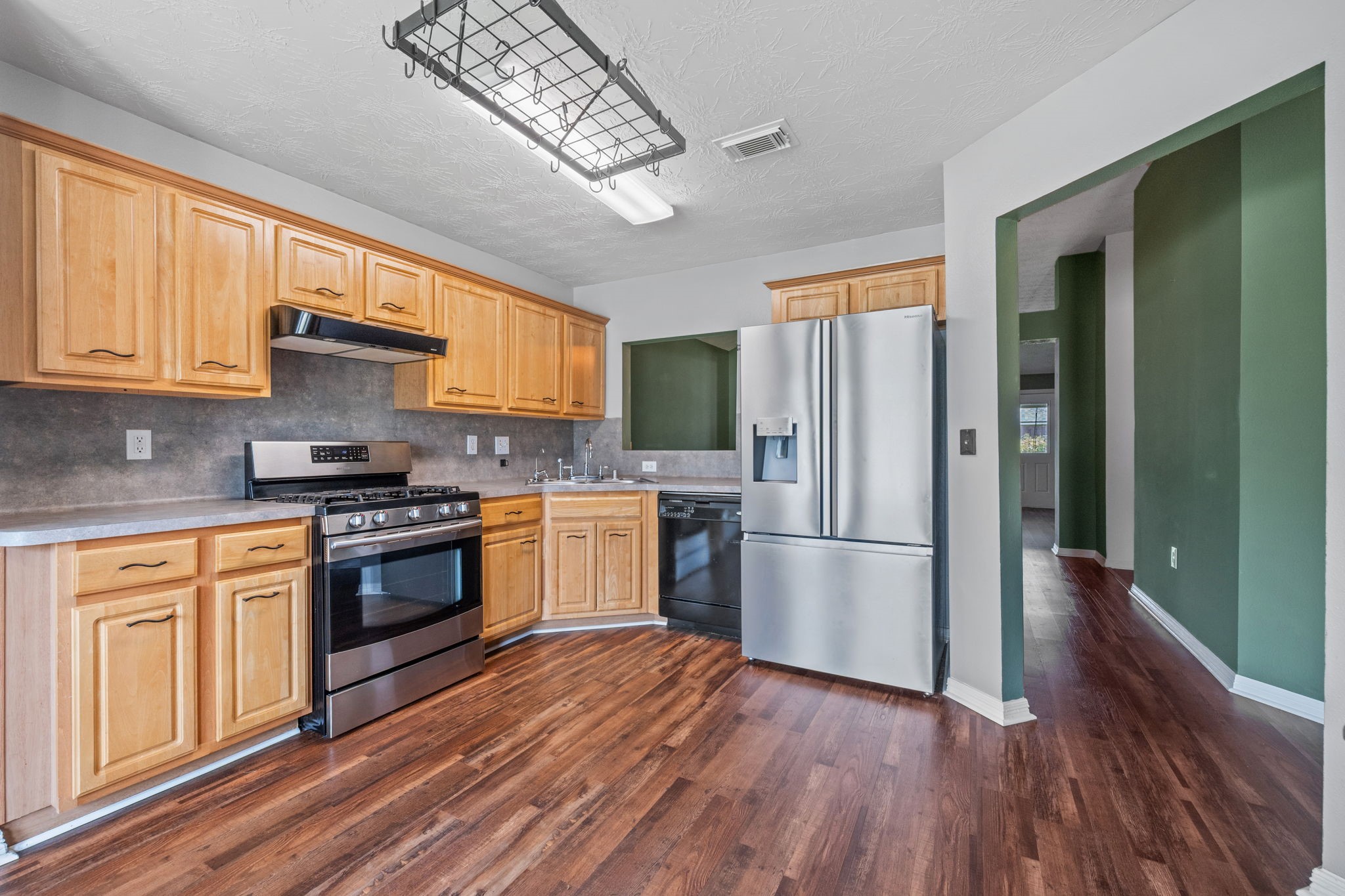 3330 Red Cedar Drive Baytown, TX 77521 - Photo 9 of 25 a kitchen with granite countertop stainless steel appliances a counter space a sink and a window