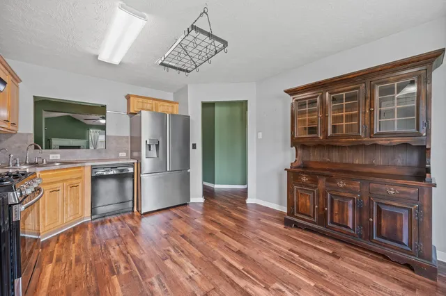 a kitchen with stainless steel appliances granite countertop a stove and cabinets