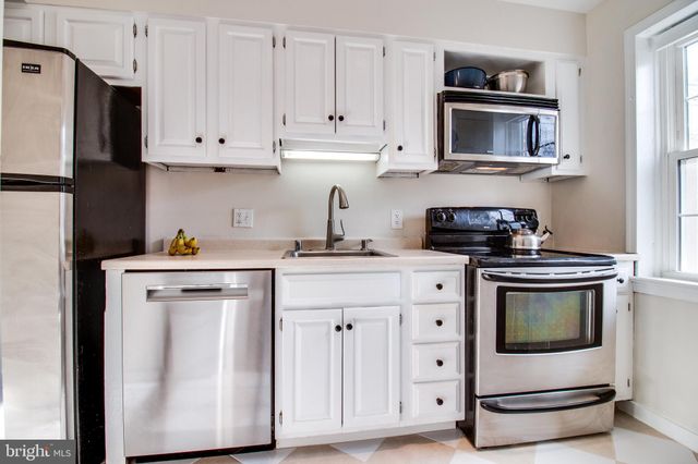 a kitchen with appliances cabinets and a sink