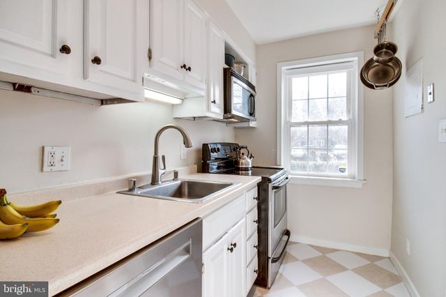 a kitchen with a sink and refrigerator