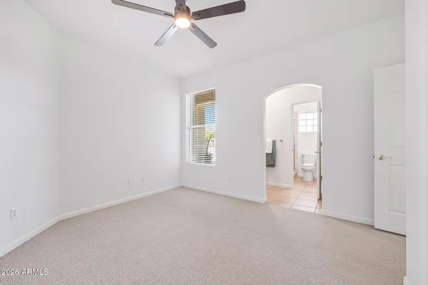 a living room with furniture kitchen view and a large window