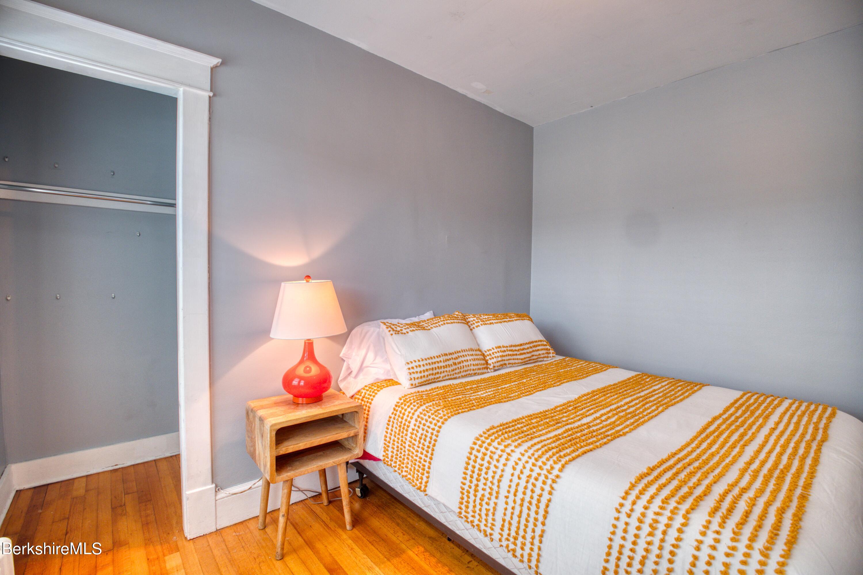 39 Catherine Street Pittsfield, MA 01201 - Photo 13 of 26 a bedroom with a bed and a painting on the wall