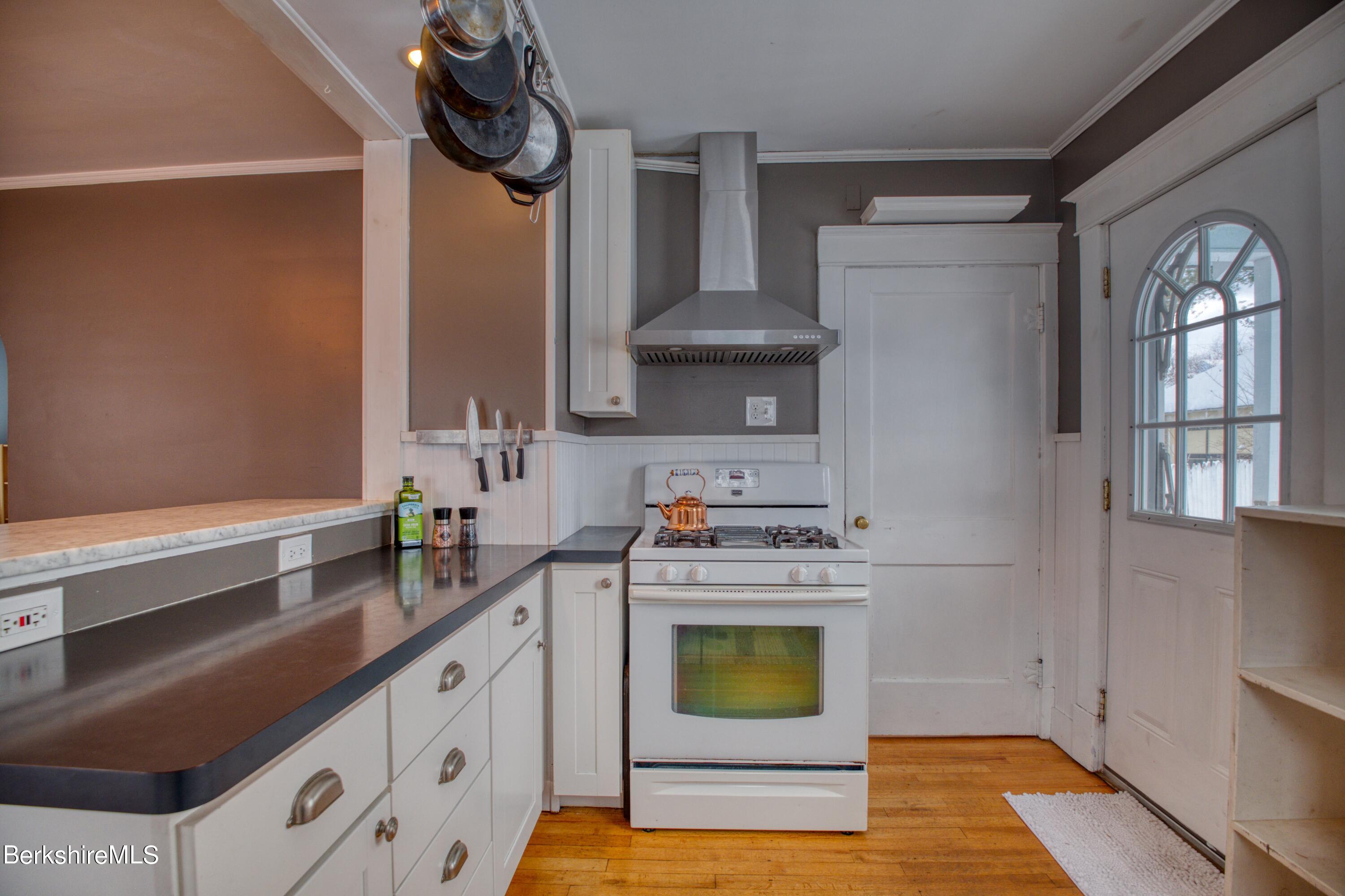 39 Catherine Street Pittsfield, MA 01201 - Photo 20 of 26 a kitchen with stainless steel appliances granite countertop a sink a stove and cabinets
