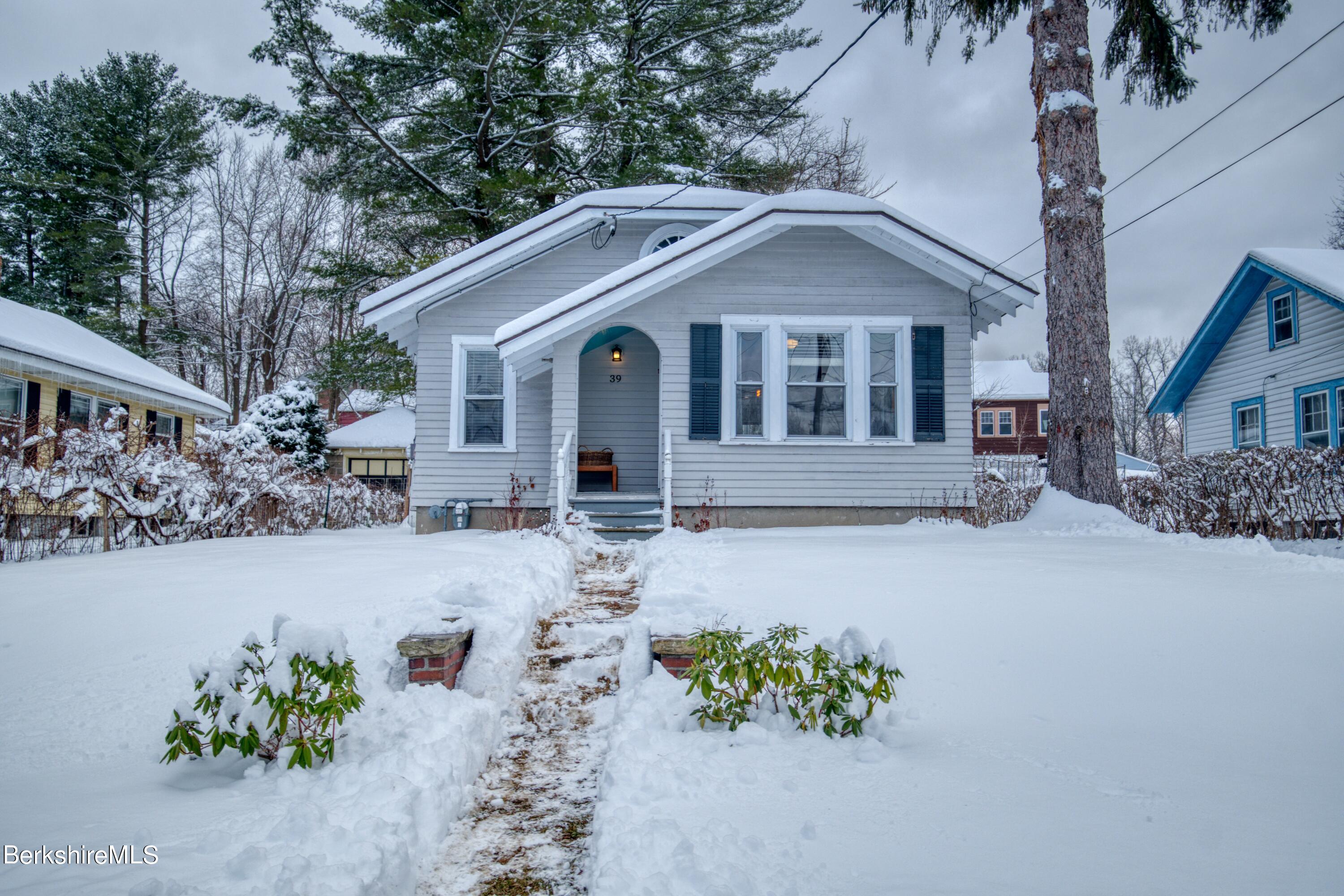 39 Catherine Street Pittsfield, MA 01201 - Photo 2 of 26 a front view of a house with a yard and a garden