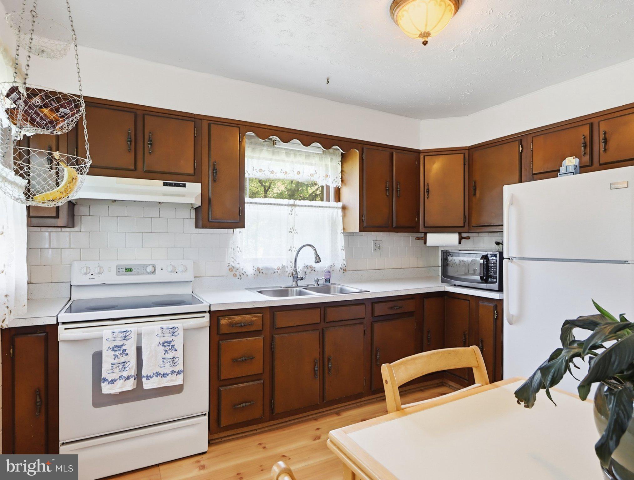 8176 Lea Road Pasadena, MD 21122 - Photo 8 of 23 Charming kitchen with classic wood accents.