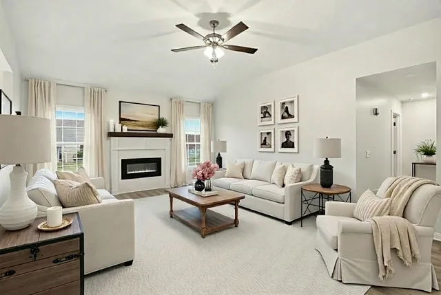 a living room with furniture a fireplace and a flat screen tv