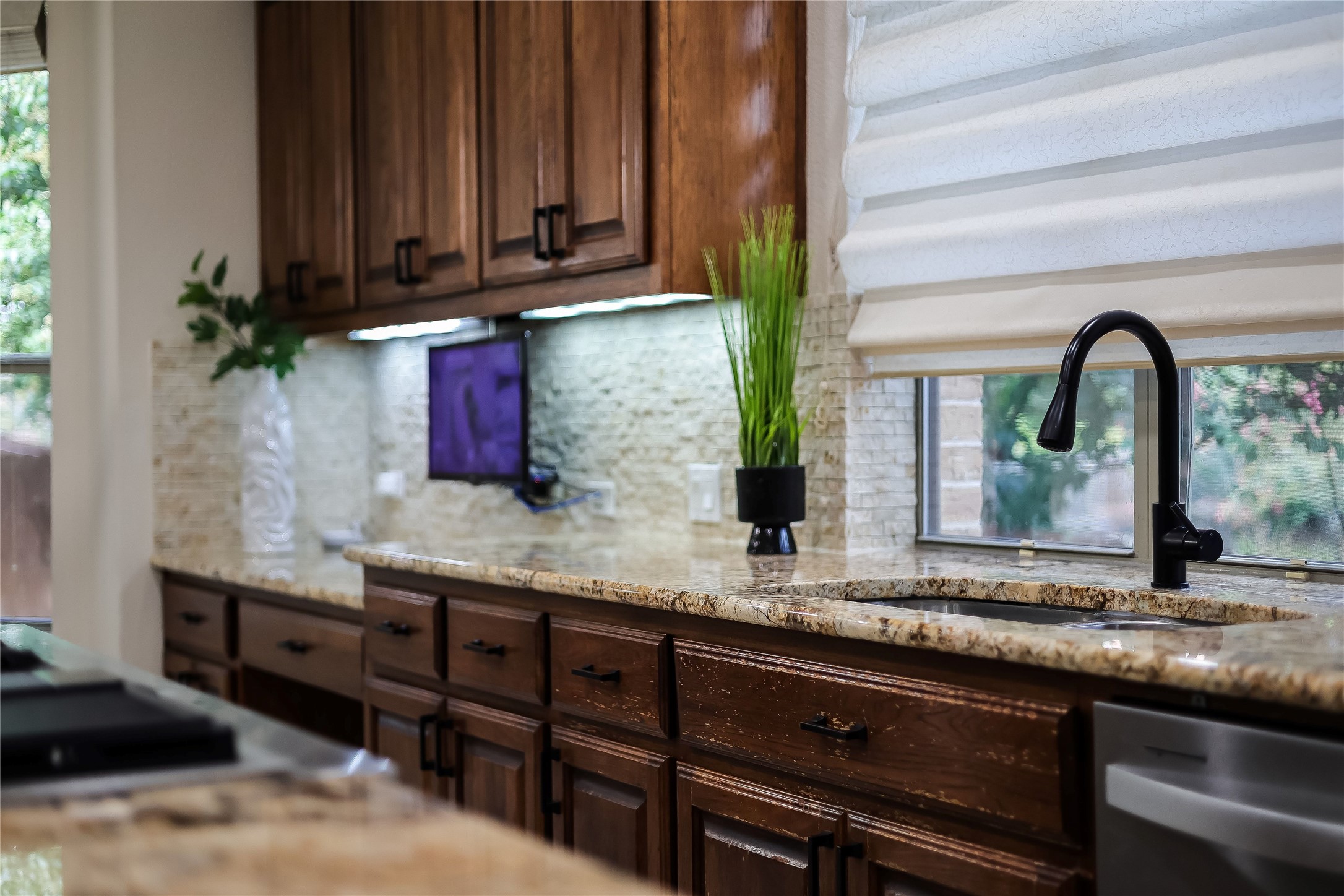408 Ridgetop Bend Cedar Park, TX 78613 - Photo 10 of 40 Rich wood cabinetry and gleaming granite counters define this inviting kitchen.