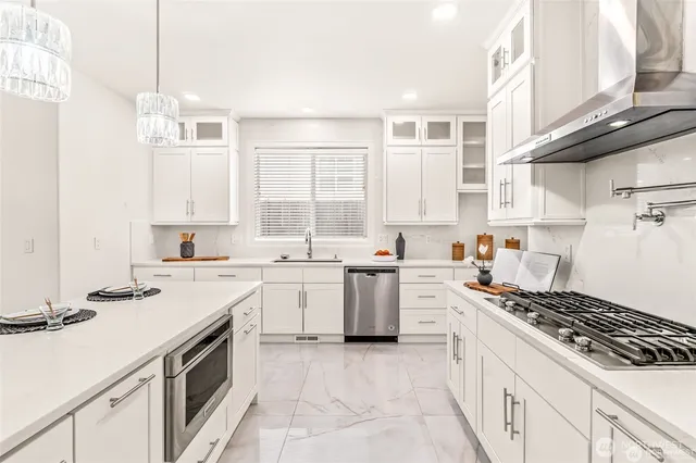 a kitchen with a stove sink and cabinets