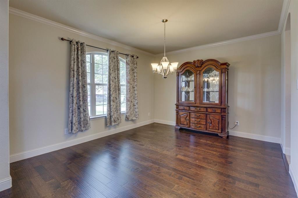 336 Red Hill Road Sunnyvale, TX 75182 - Photo 17 of 36 an empty room with wooden floor chandelier and glass door