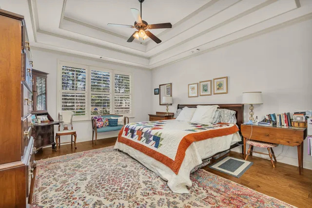 a bedroom with a bed dresser and a window