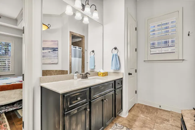 a bathroom with a sink a vanity and a mirror