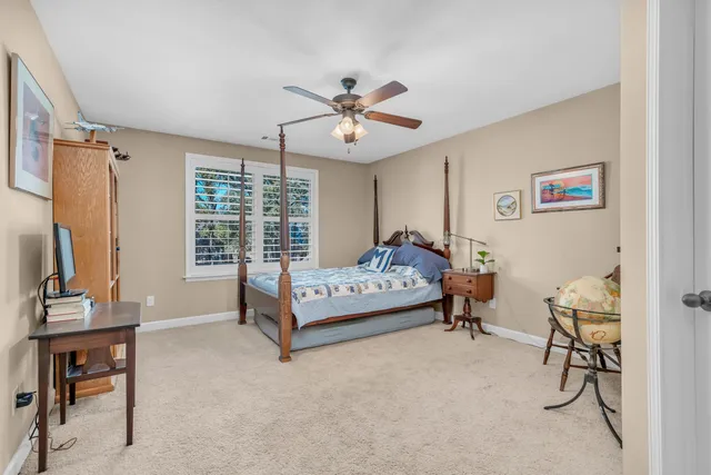 a bedroom with furniture and a window
