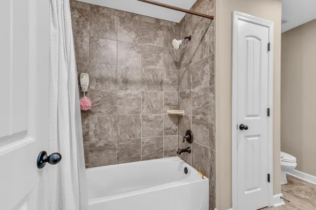 a bathroom with a bathtub and shower