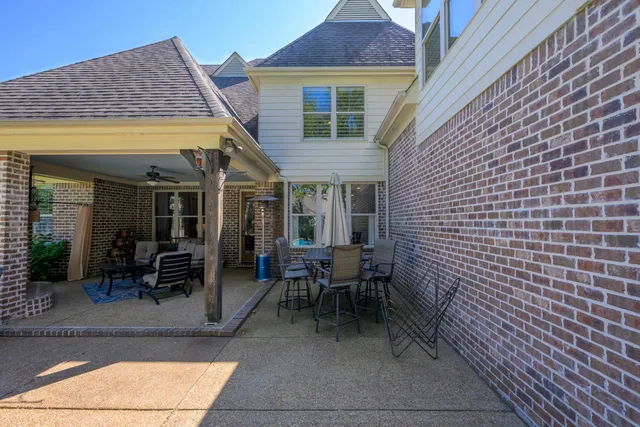 a view of a patio with table and chairs and potted plants