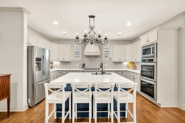 a large kitchen with a table and chairs