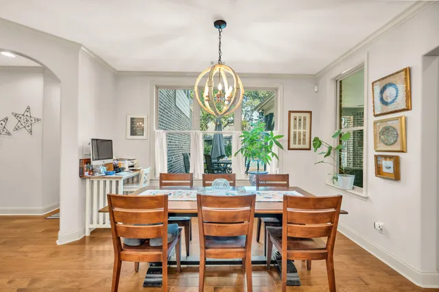 a dining room with furniture a rug and a chandelier