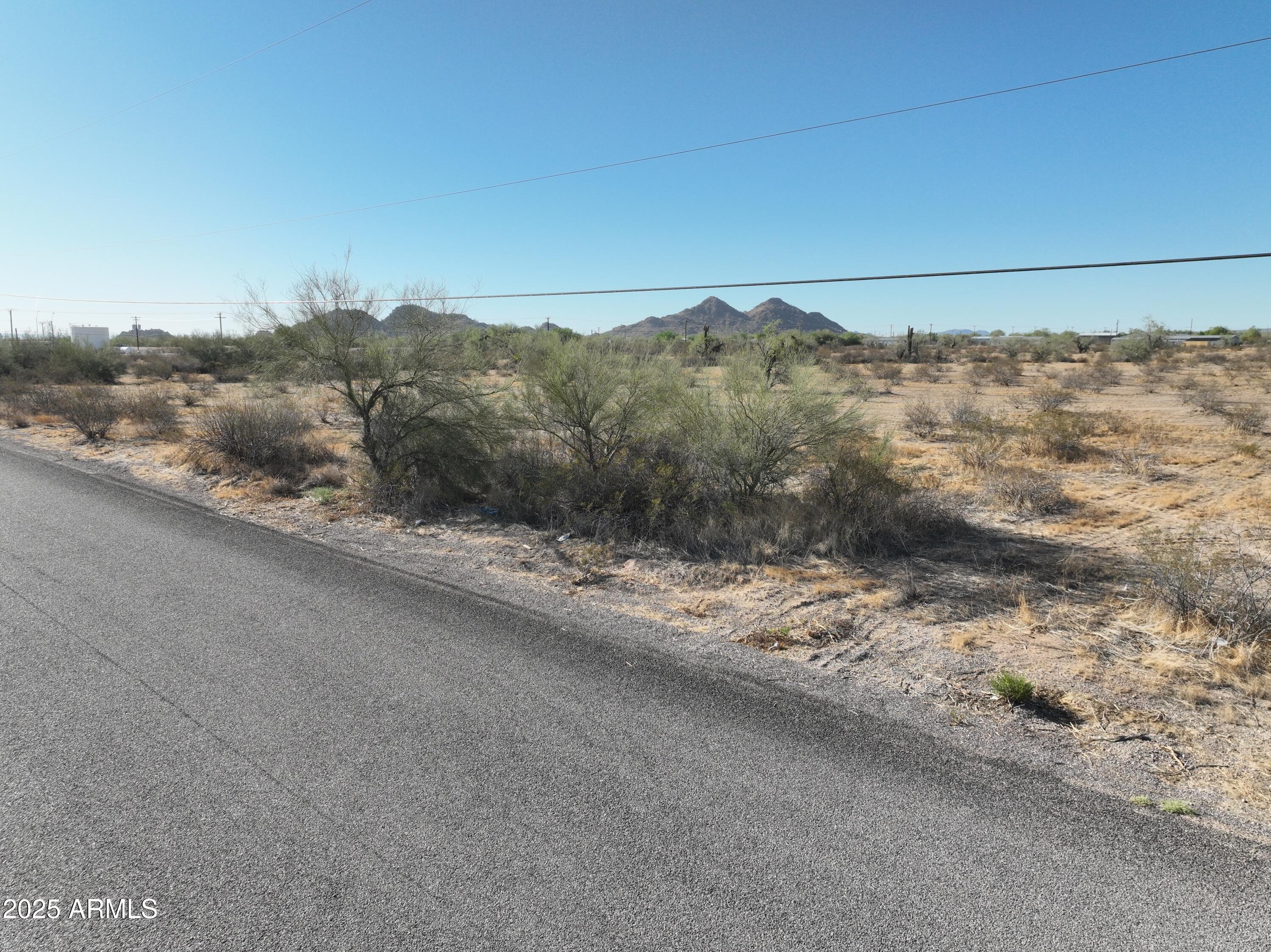 0 West Huisatch Road, Unit 191 Maricopa, AZ 85139 - Photo 11 of 20 a view of a road from a covered with snow in the background