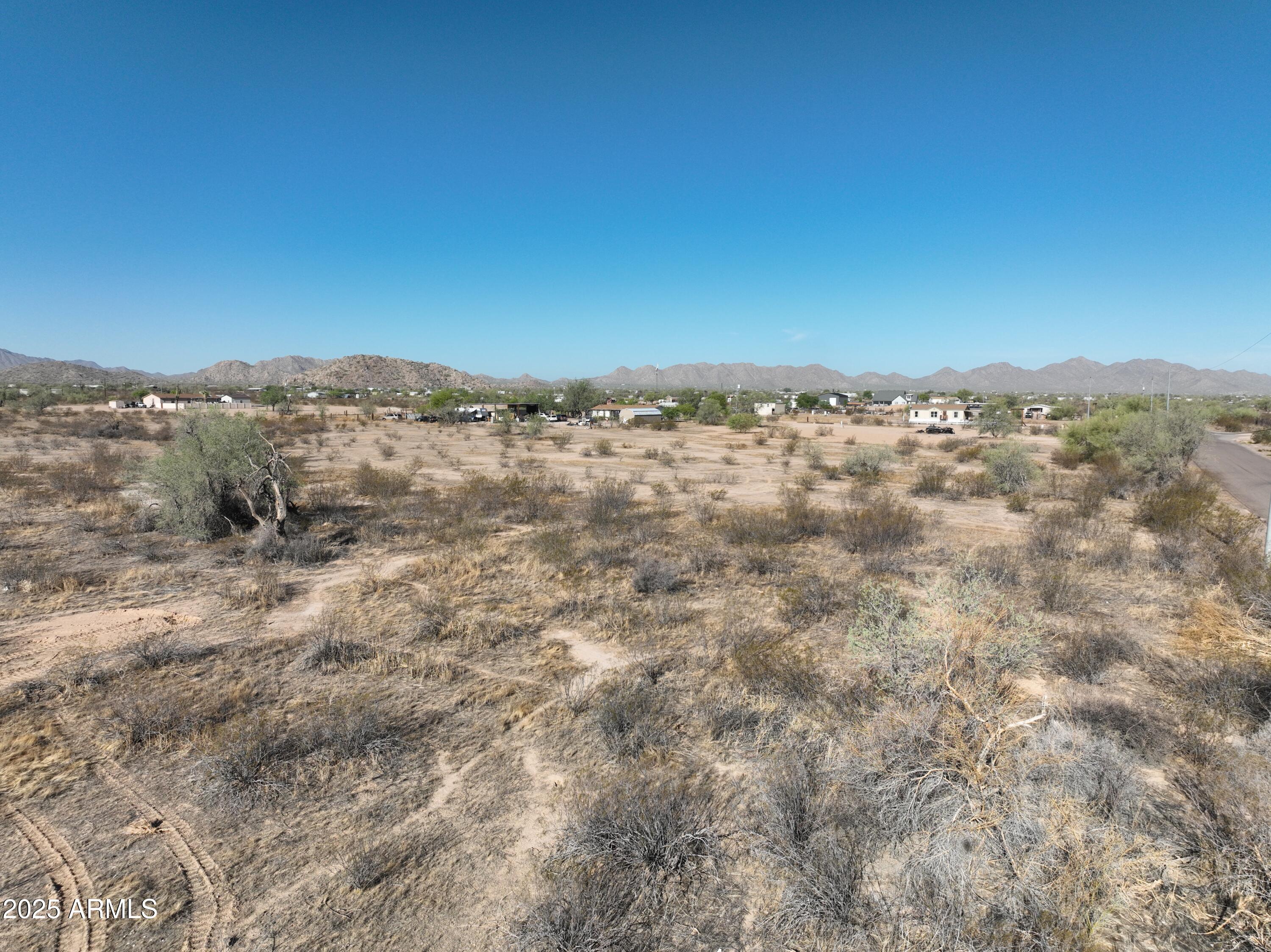 0 West Huisatch Road, Unit 191 Maricopa, AZ 85139 - Photo 14 of 20 a view of a large building with mountains in the background