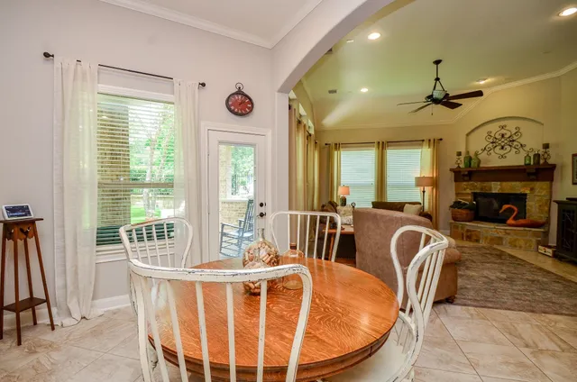 a dining room with furniture a fireplace and a chandelier